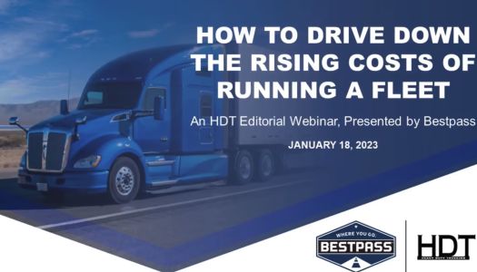 A dark blue tractor trailer is going down the road. To the right is white text that reads "How To Drive Down The Rising Costs Of Running A Fleet - An HDT Editorial Webinar, Presented by Bestpass, January 18th, 2023." At the bottom right corner is a white triangular space, showing the HDT logo and the Bestpass logo.